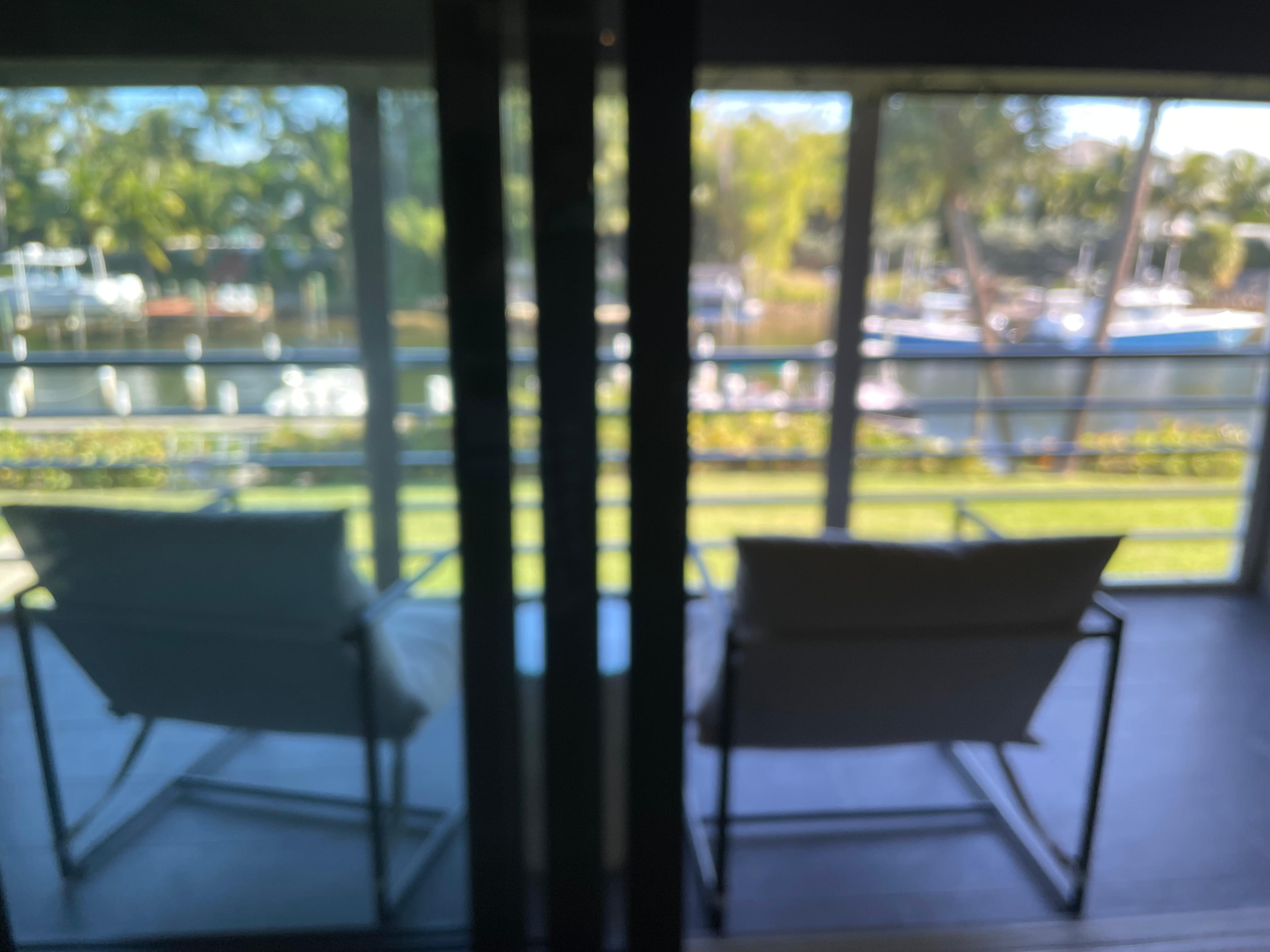 Lovely porch looking at the water & pretty boats! 