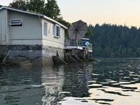 Photo in kayak at high tide of cabin.