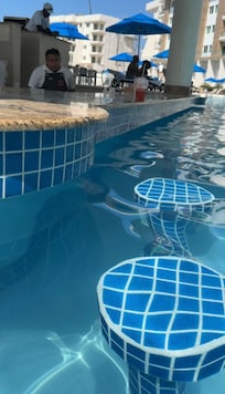 Seats at the bar iin the pool with cover.