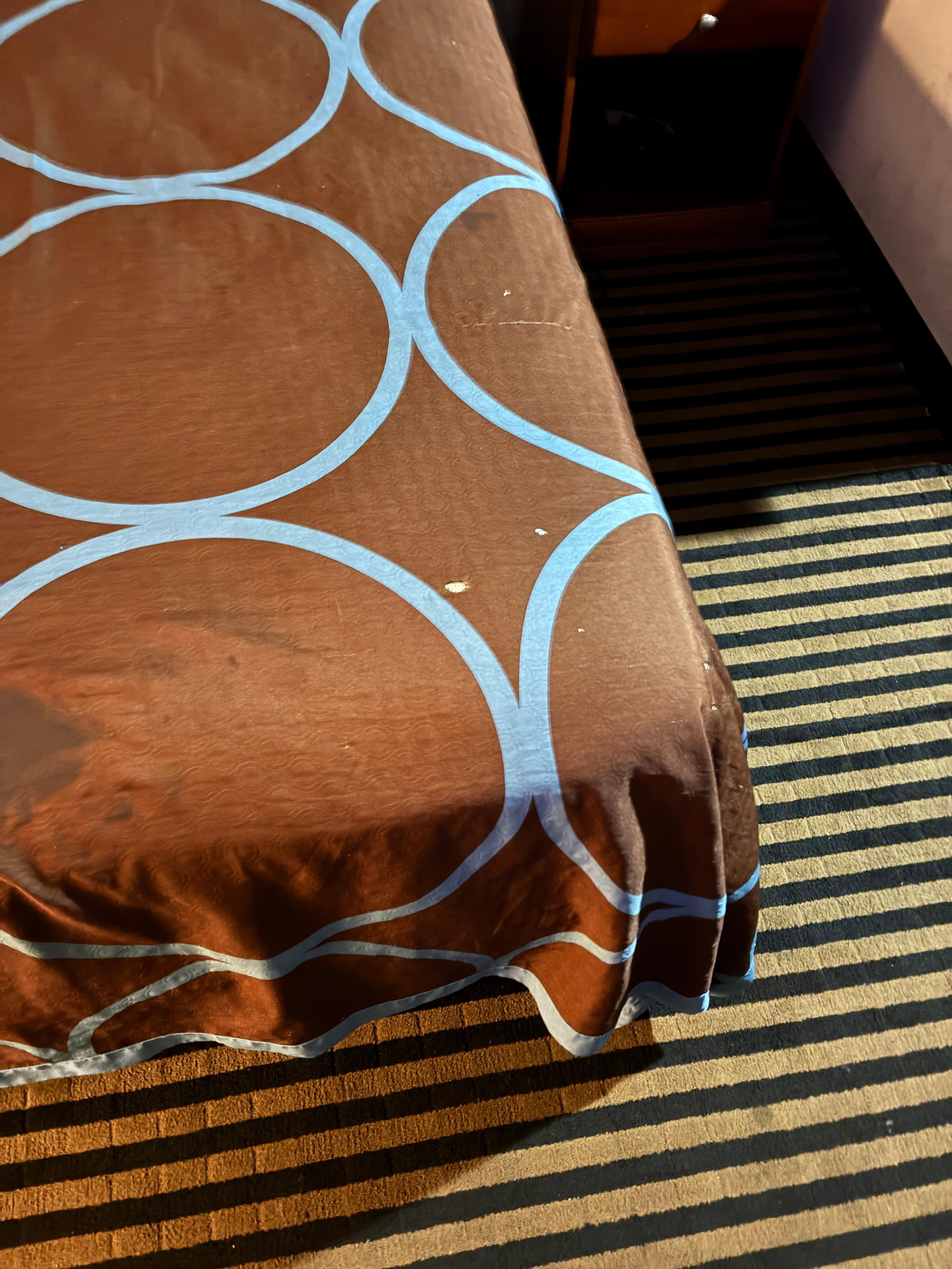 cigarette burns on bed cover