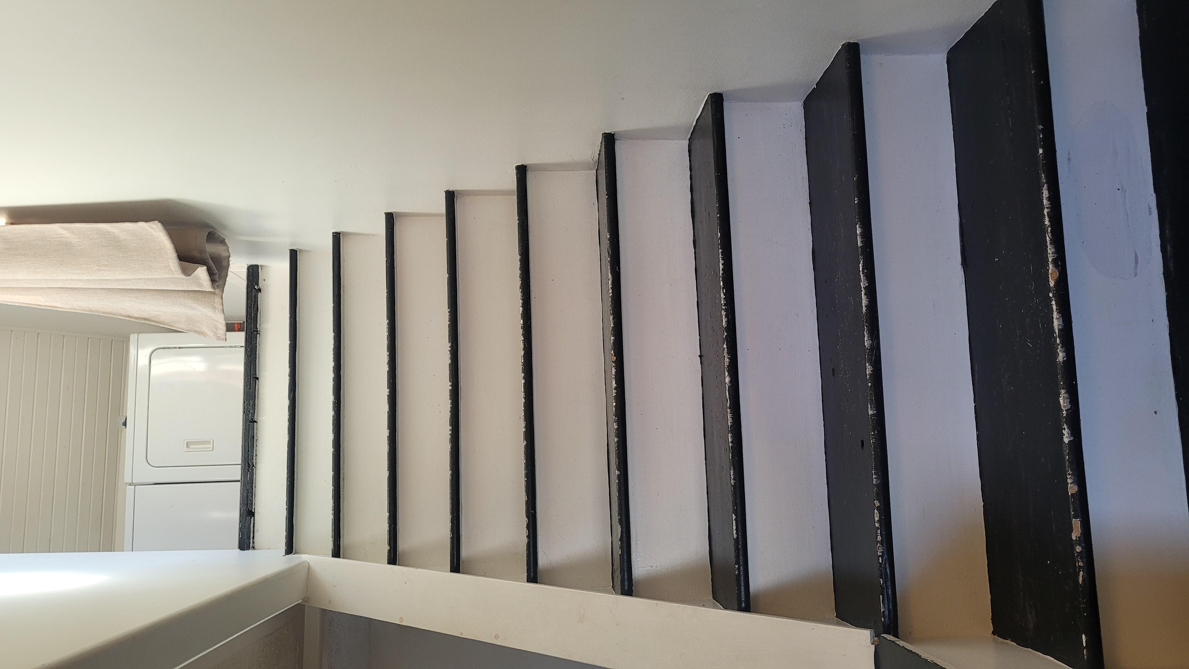 Stairs to the upstairs bedroom. Note, no handrail.