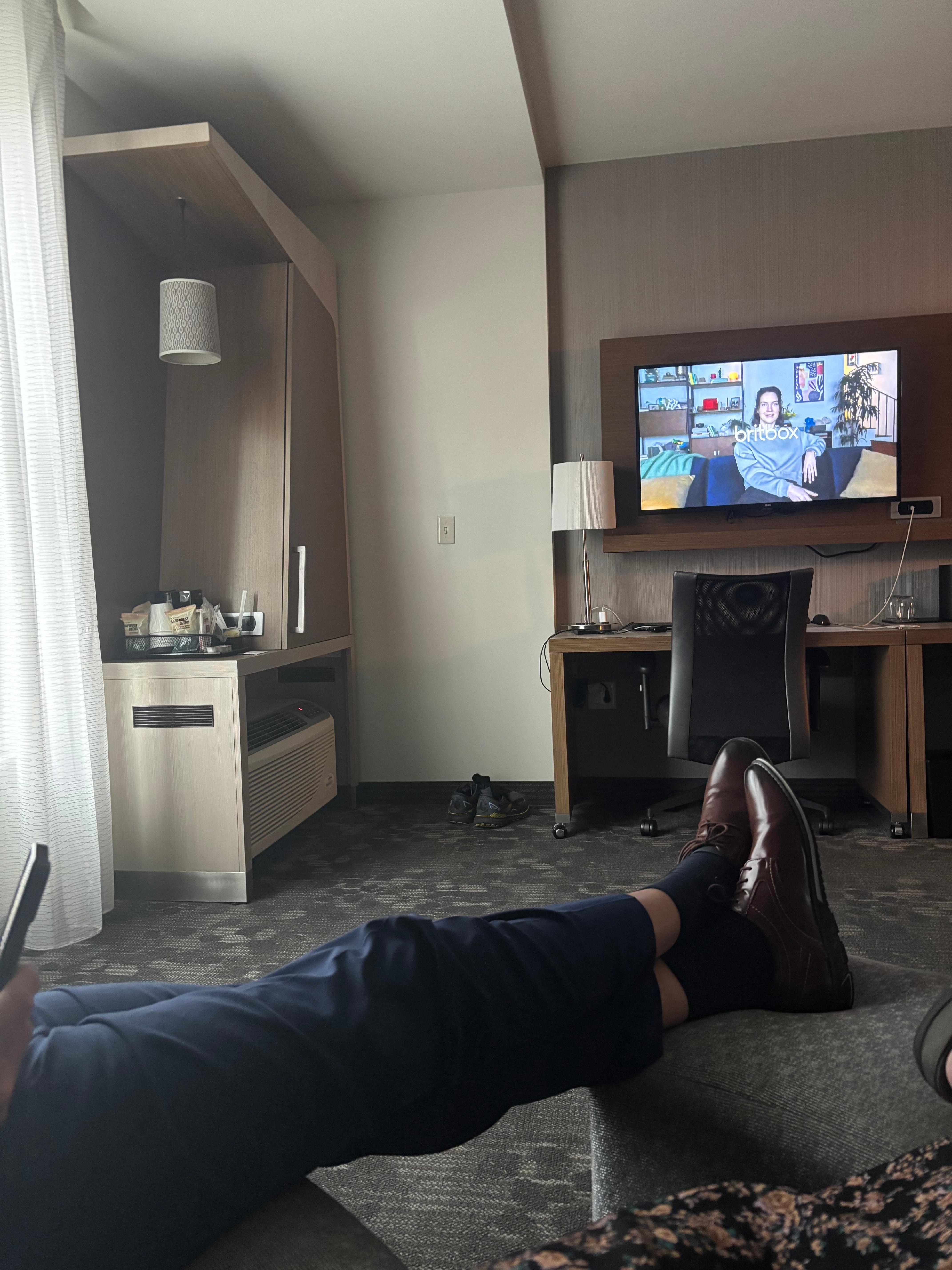 Window, desk, TV and coffee/ microwave /fridge area