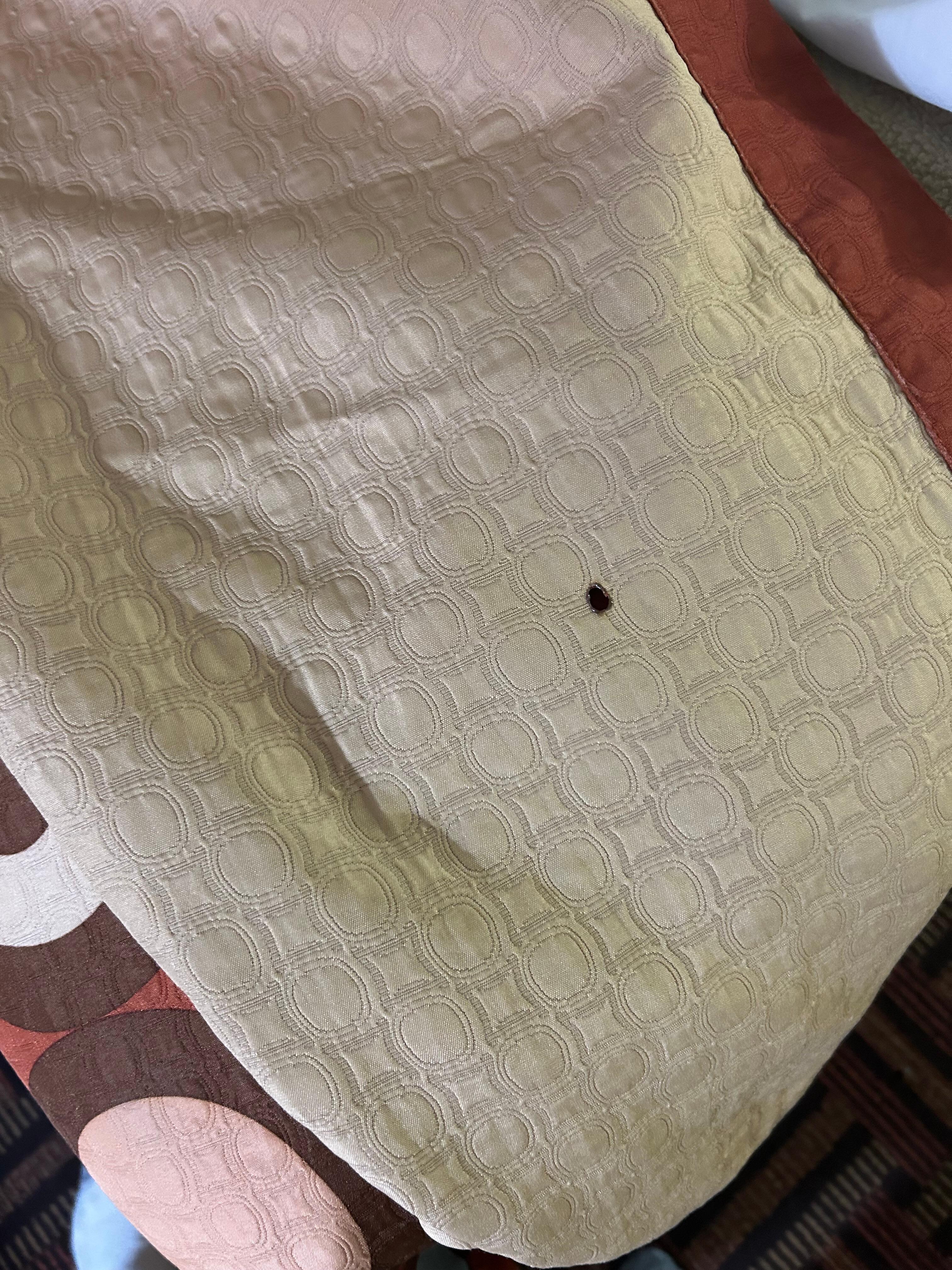 Cigarette burn on the comforter. Replace it!
