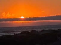 Sunset over the dunes and beach 1 block from Captain Java's Cottage.