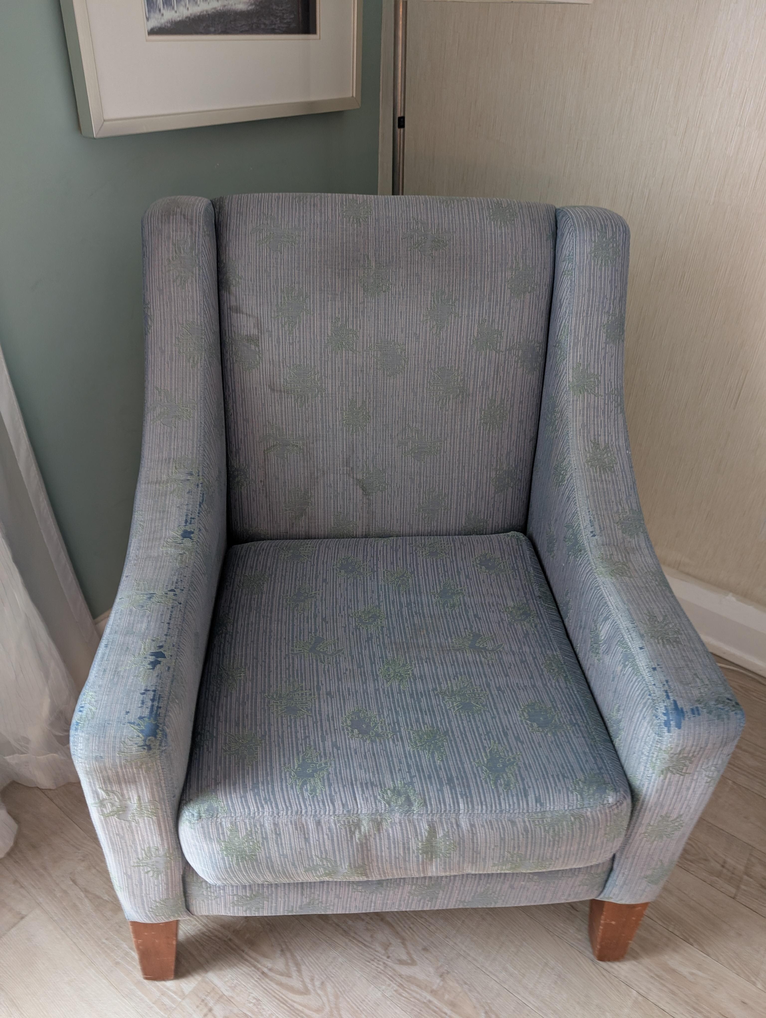 Threadbare upholstered chair.