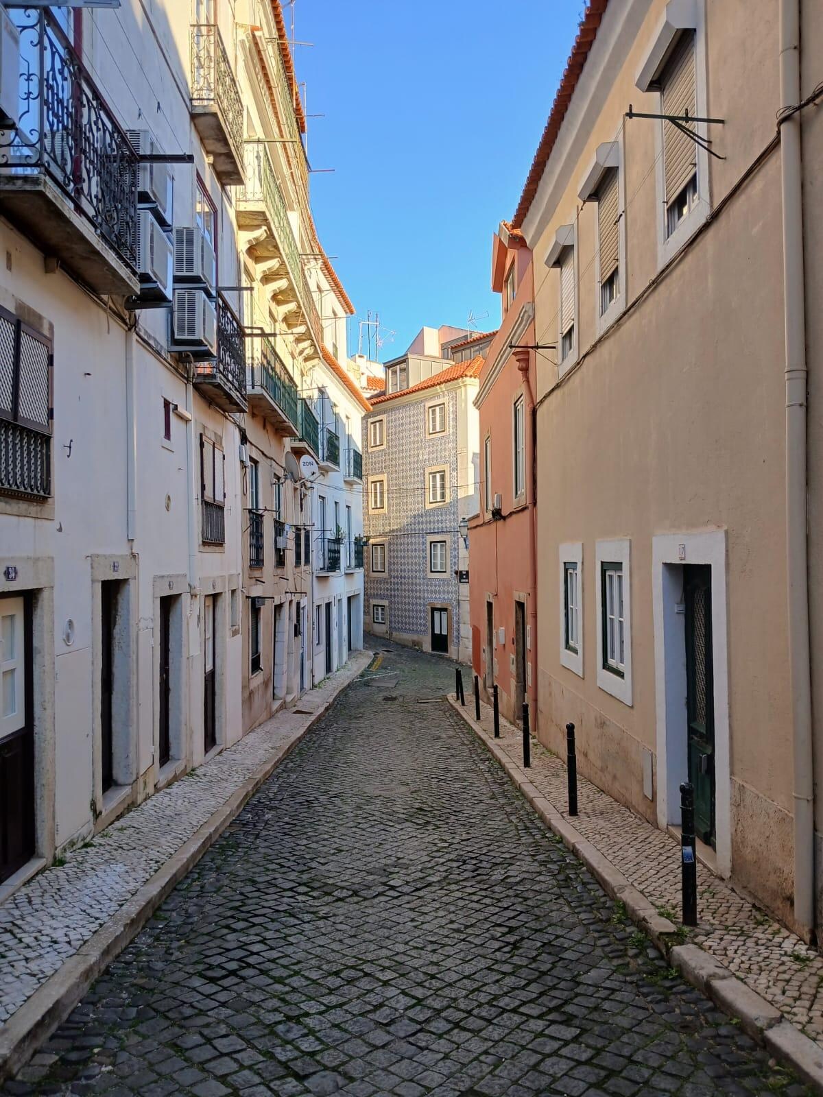 Standing at the front door, looking down the street into the Alfama