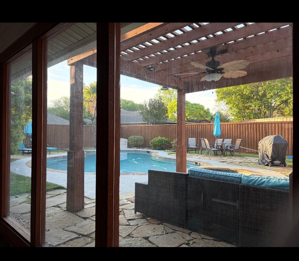 View from an outdoor enclosed porch with morning coffee. 