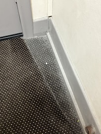 Lost pill behind the front door, clearly never vacuumed