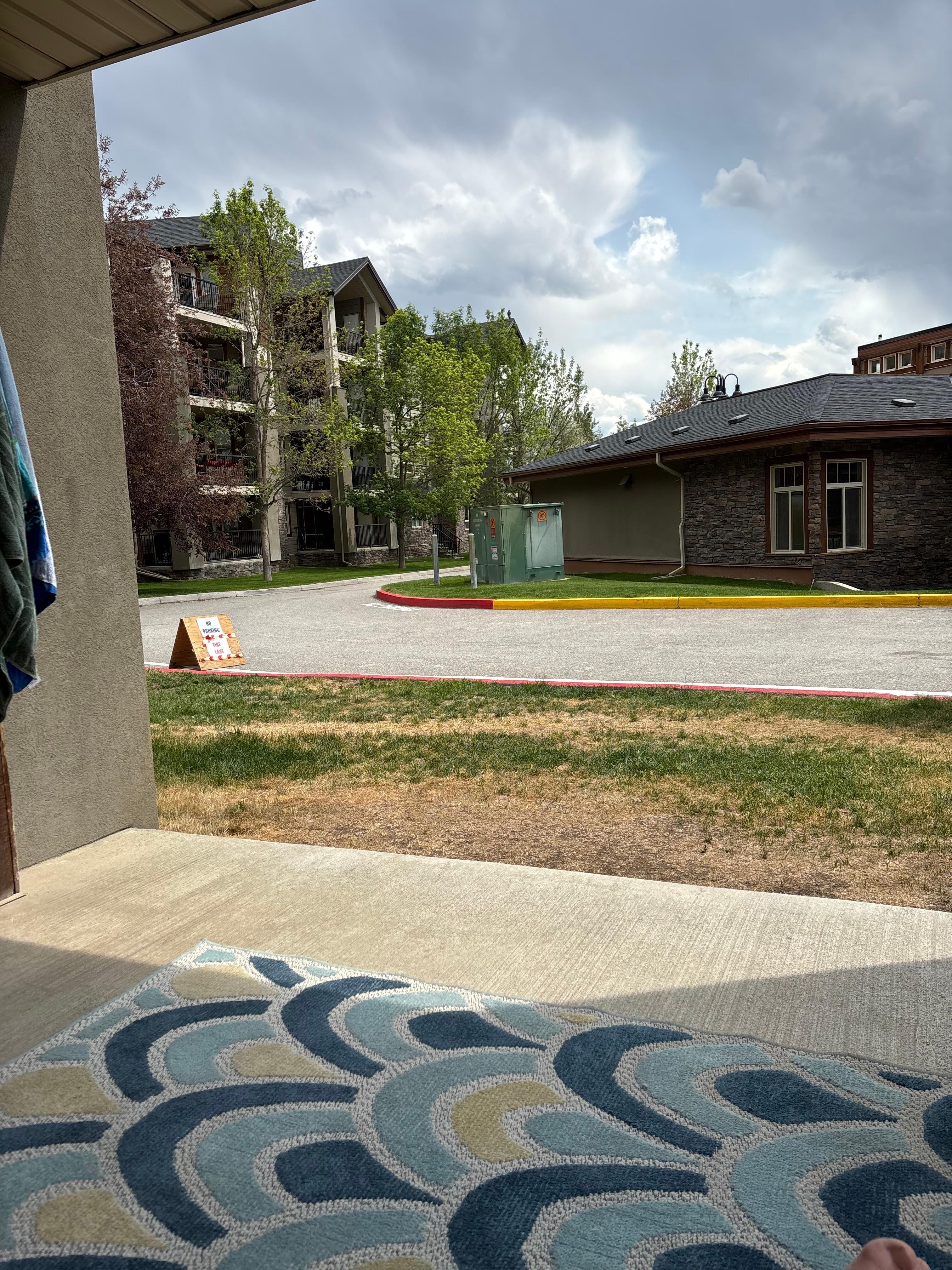 Sitting on the patio directly across from pool house and gym.