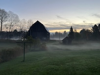 The moody barn and yard at dawn.