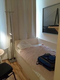 Bed area with TV on wall