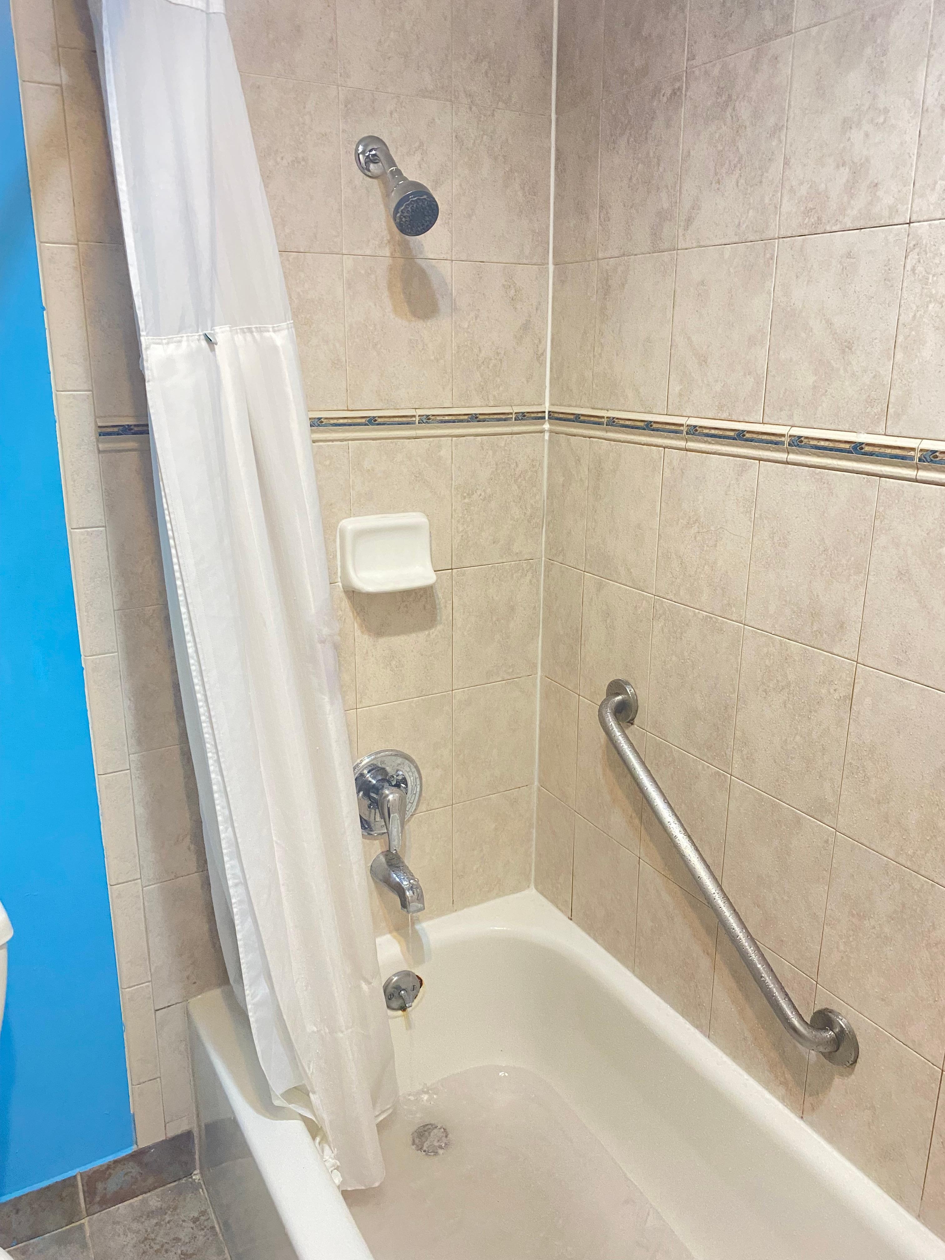 The shower head 5’3 people have to bend backwards to use