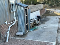 Back side of cottage closest to house full of trash