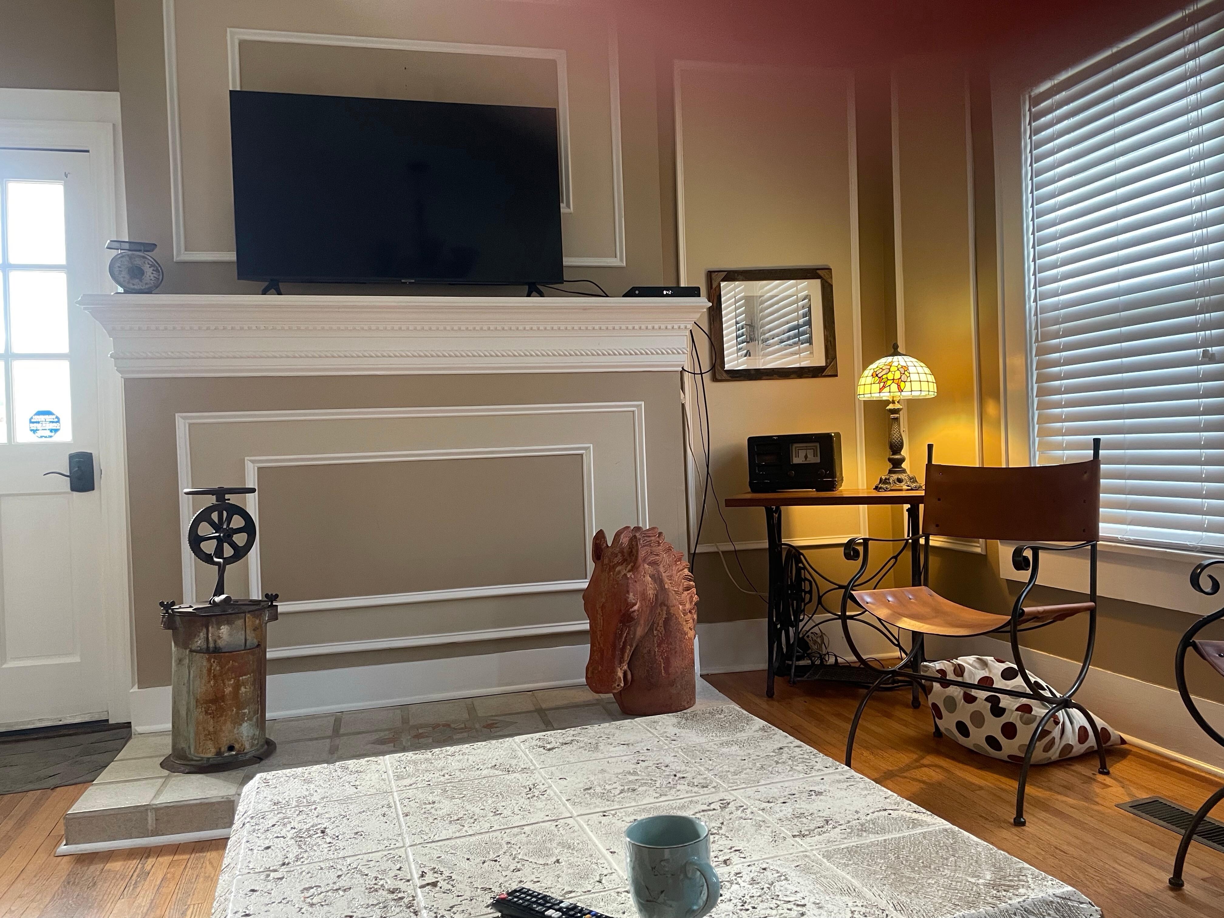 Main living room well lit, spacious with easy to operate TV and comfortable seating.