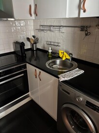 Kitchen with essentials for AM coffee, PM laundry