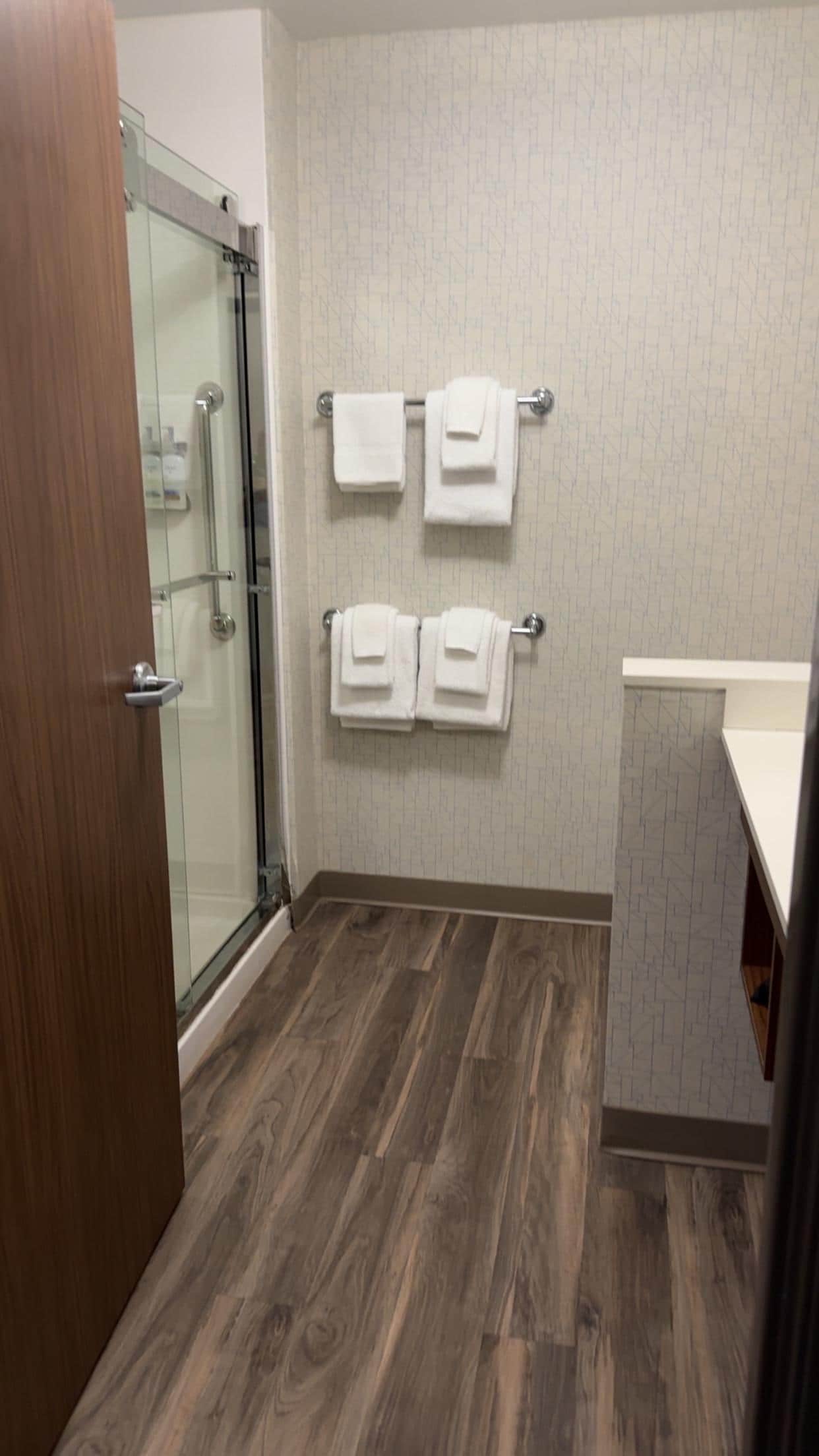 Nice warm shower with shampoo, conditioner and body wash on rack 