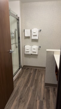 Nice warm shower with shampoo, conditioner and body wash on rack