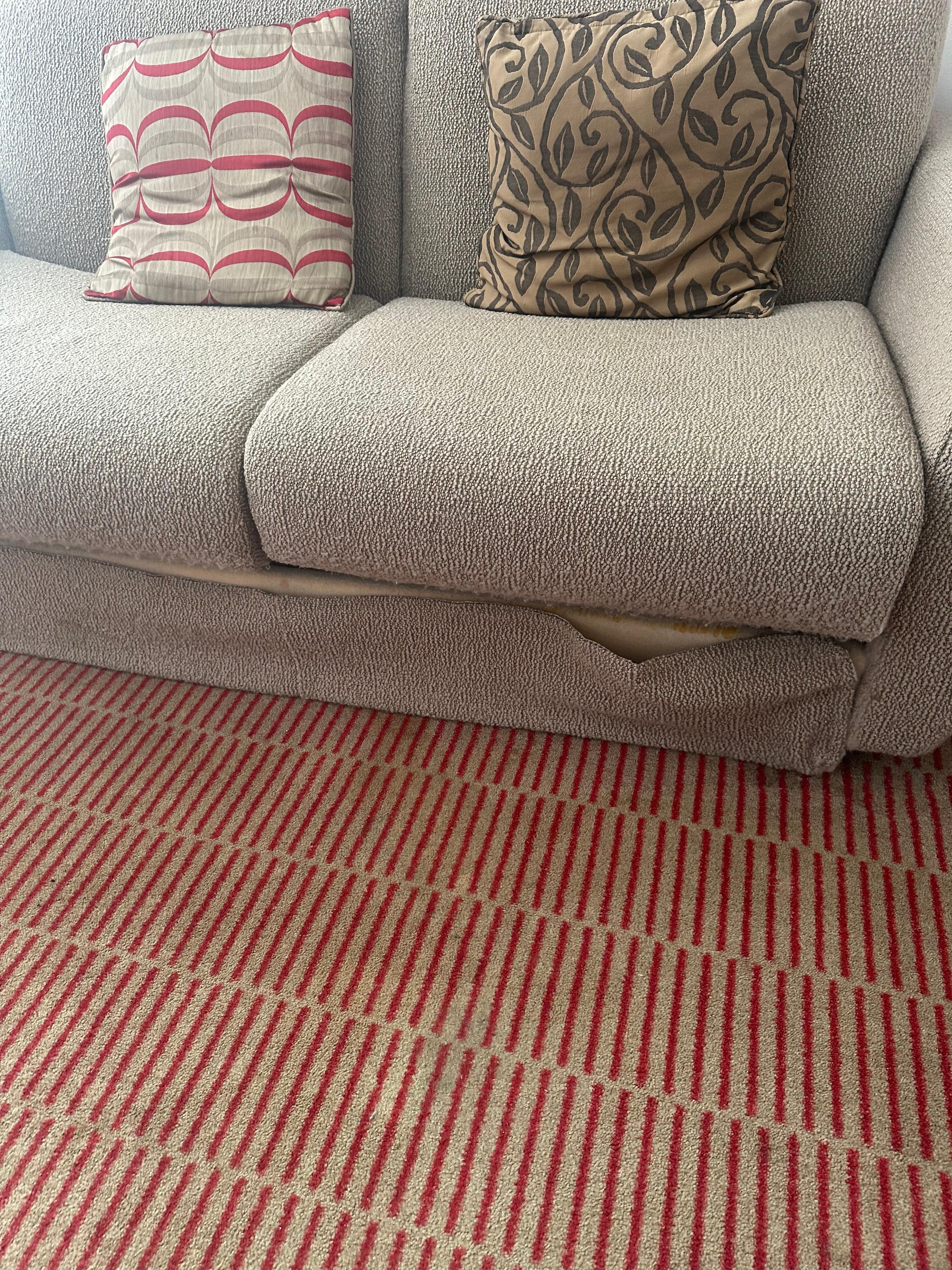 Sofa, very tired and  lacking in room preparation.