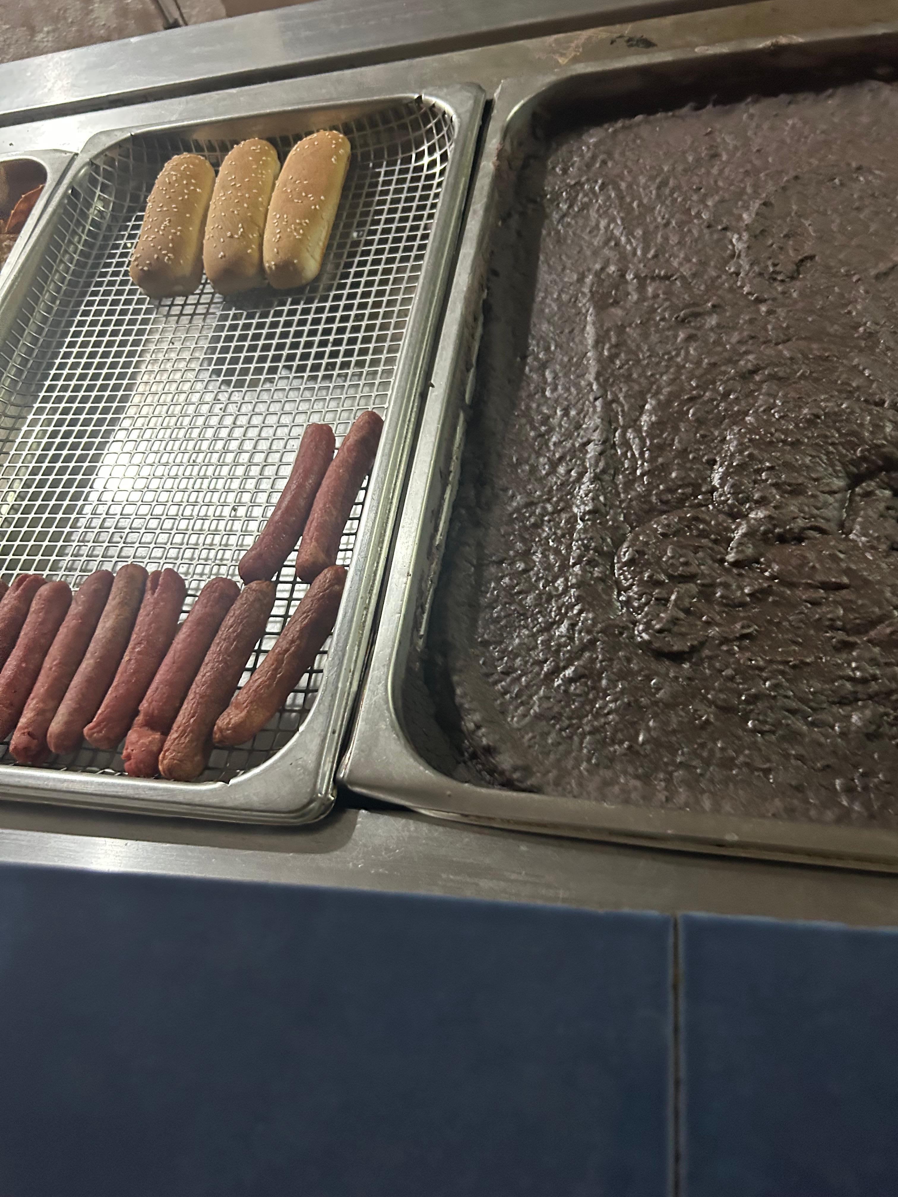 This is the tray with hot dogs beans and bread sitting all day. No temperature check on food. This was so scary and disappointing to see. 