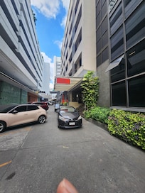 Location is off the street. Sometimes hard for Grab driver's to find lobby entrance. It is next to Trinity Complex.