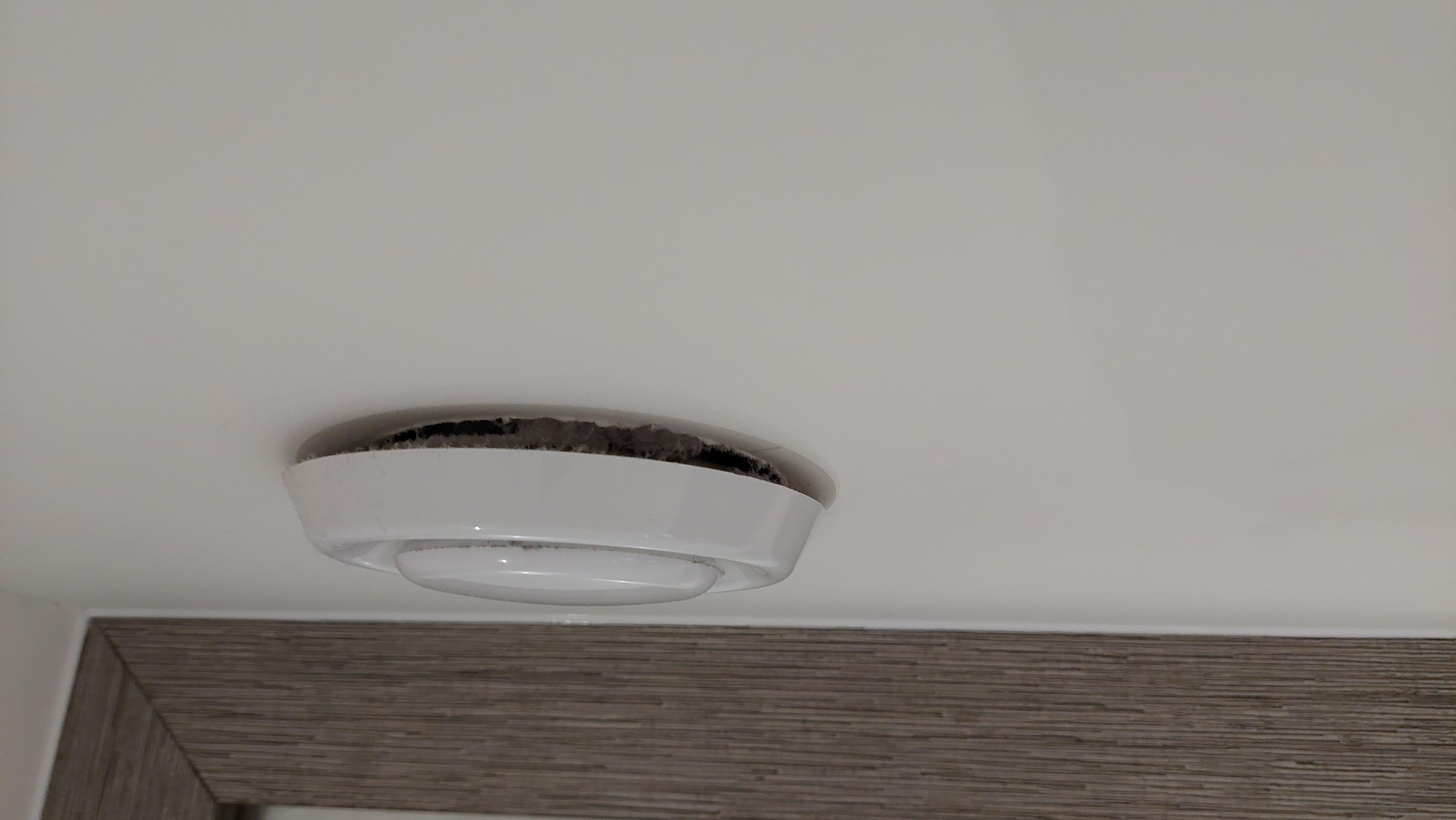 Extractor fan lose at the wall, not fitted flush.