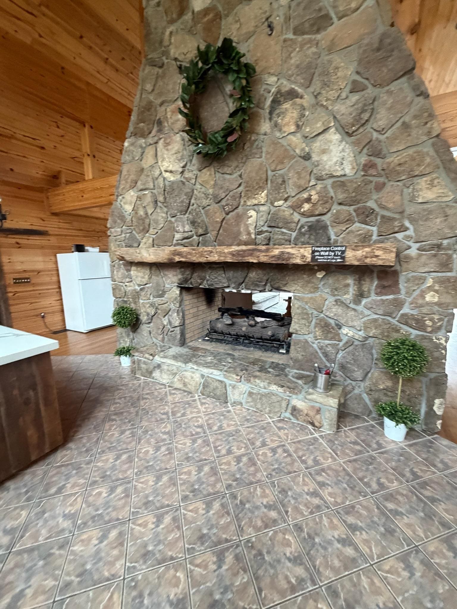 Huge fireplace connecting the kitchen and living area