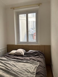 Bedroom with no light fixture dirty window no curtain