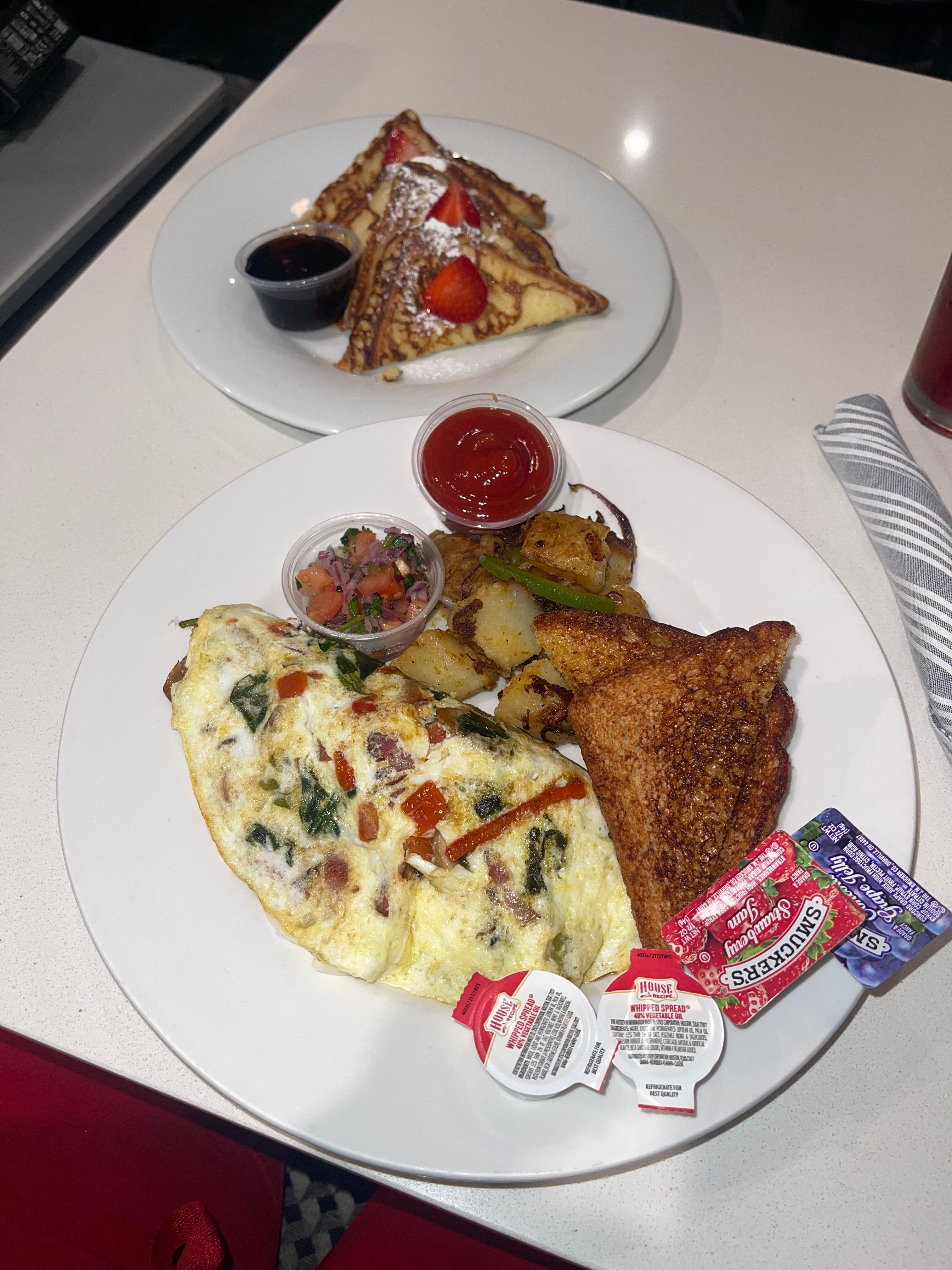 Veggie omelette entree (add bacon) with a side of French toast.