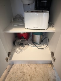 Another kitchen cabinet with stuff just thrown in. Filthy and sticky residue.