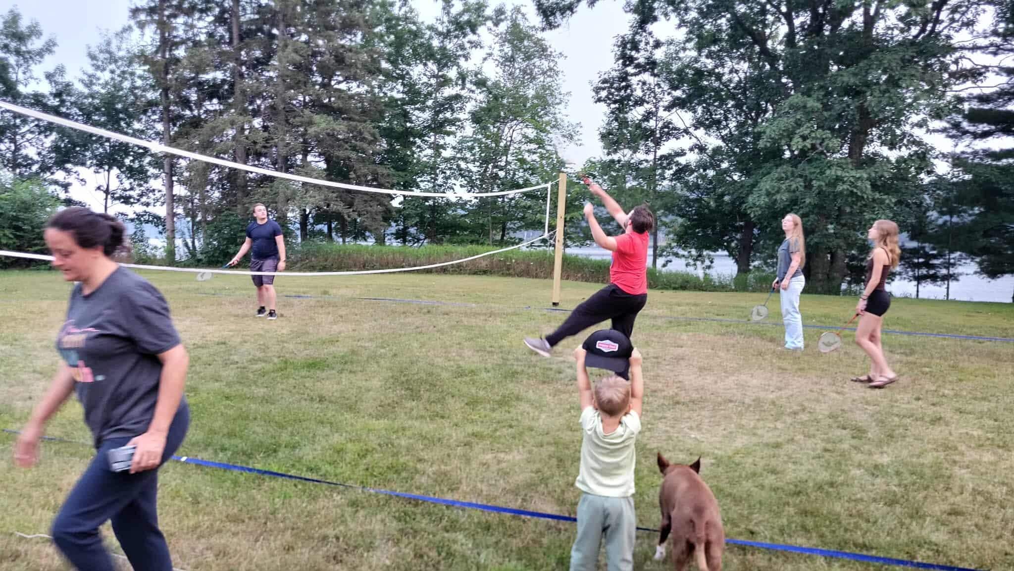 Family badminton game, with cheering section