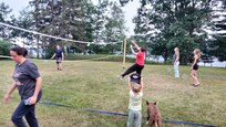 Family badminton game, with cheering section