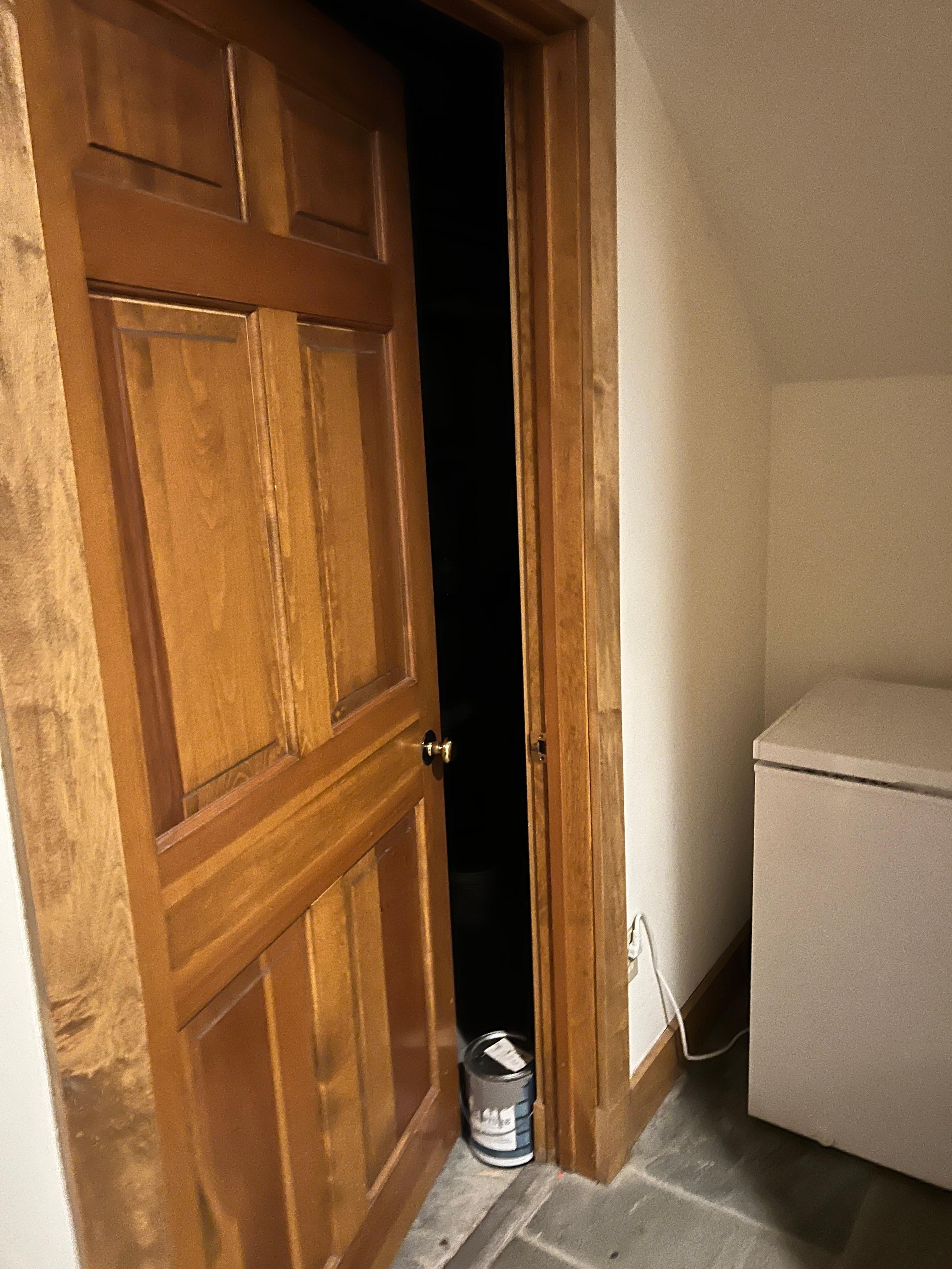 Utility room door held open by paint can