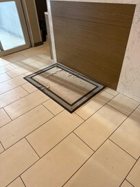 Ripped rug at the front desk.