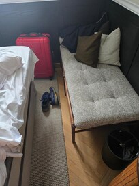 Tiny space to negotiate past the bed with toe-stubbing chair legs