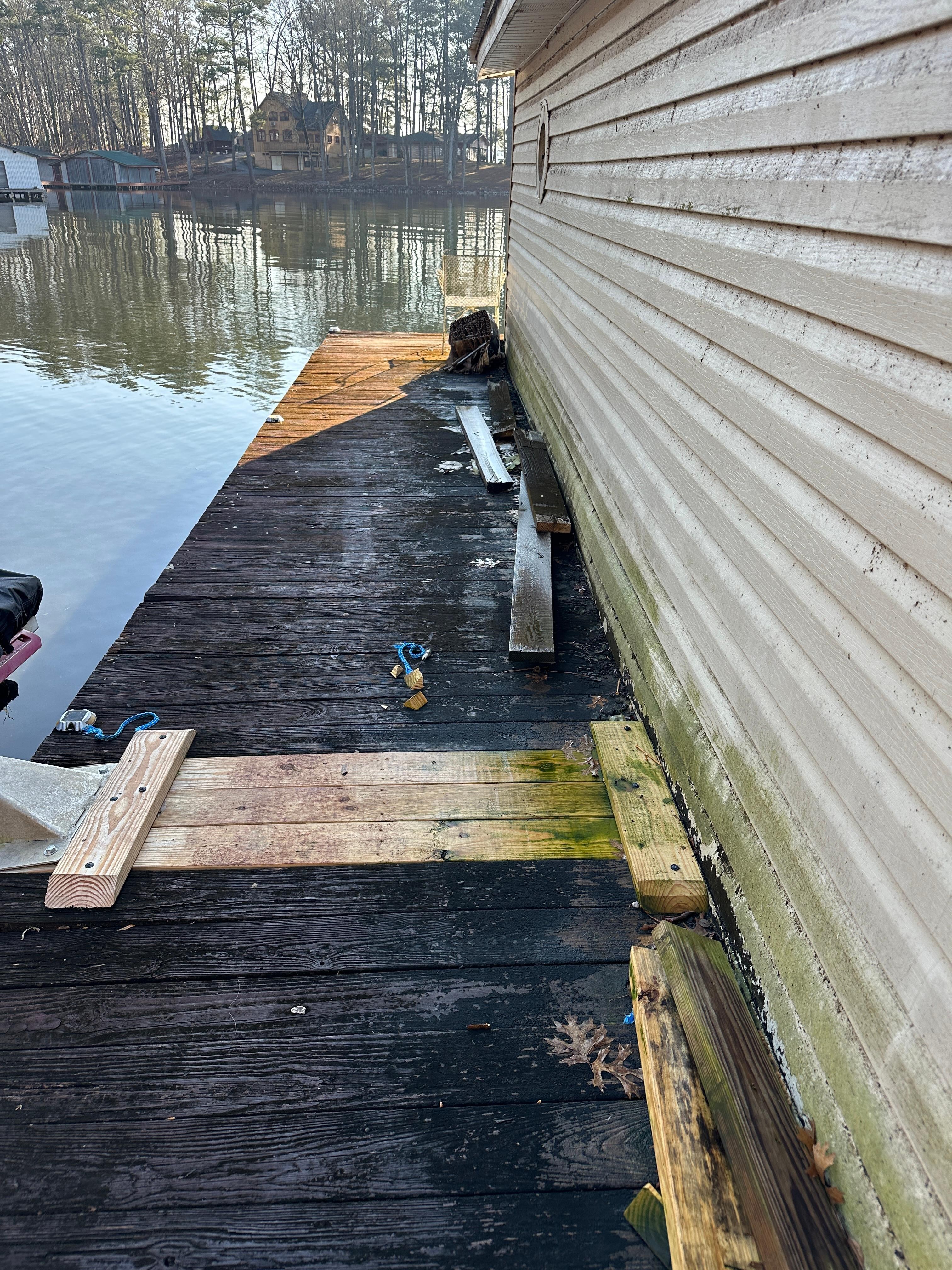 The dock on the NW side of the dock with trash and slick mildew.
