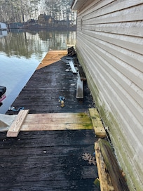 The dock on the NW side of the dock with trash and slick mildew.
