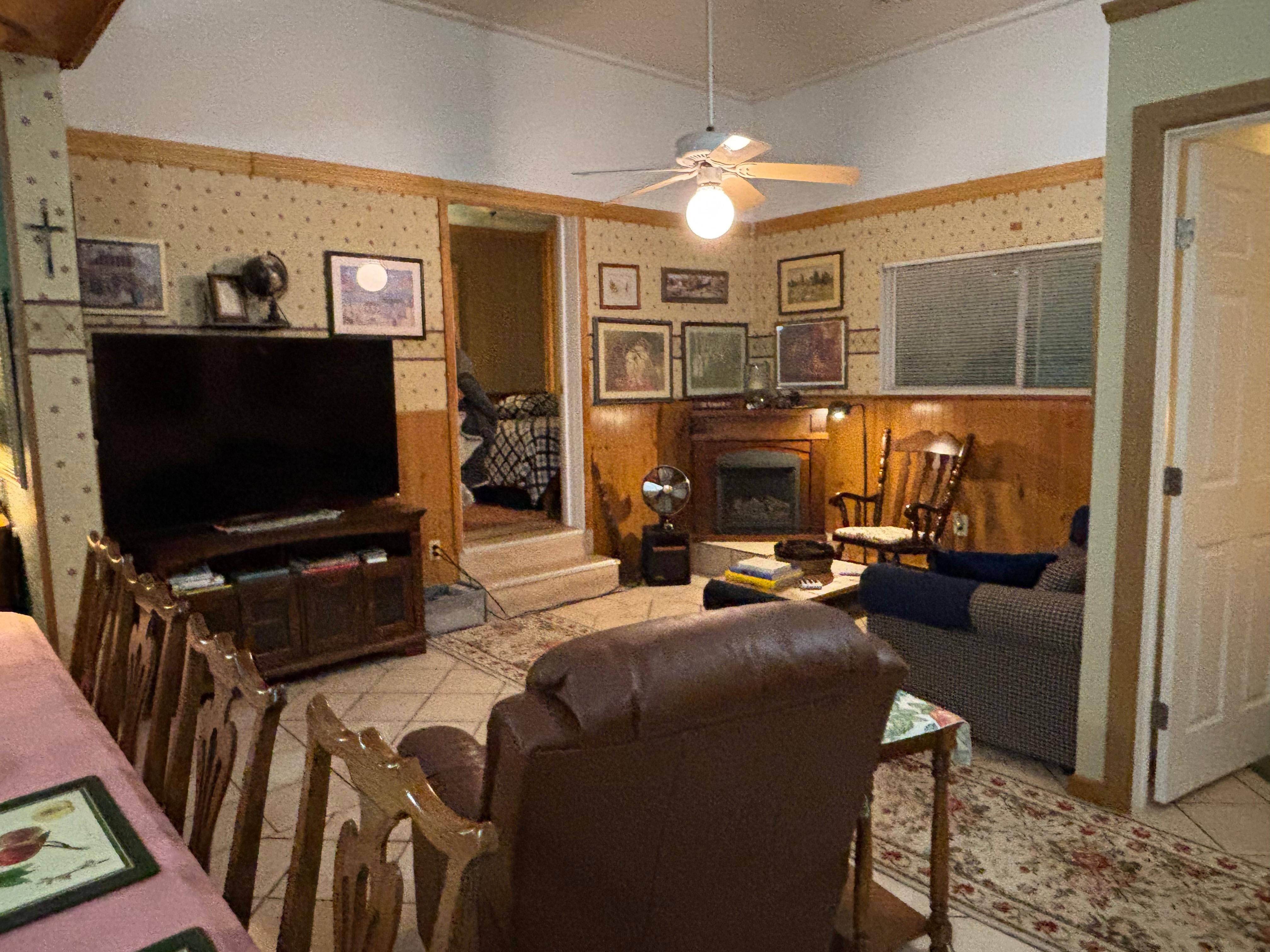 Living room area with 1 of the bedrooms visible in the back 