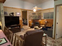 Living room area with 1 of the bedrooms visible in the back