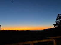 Moon above an ocean-view sunset from the wraparound balcony.