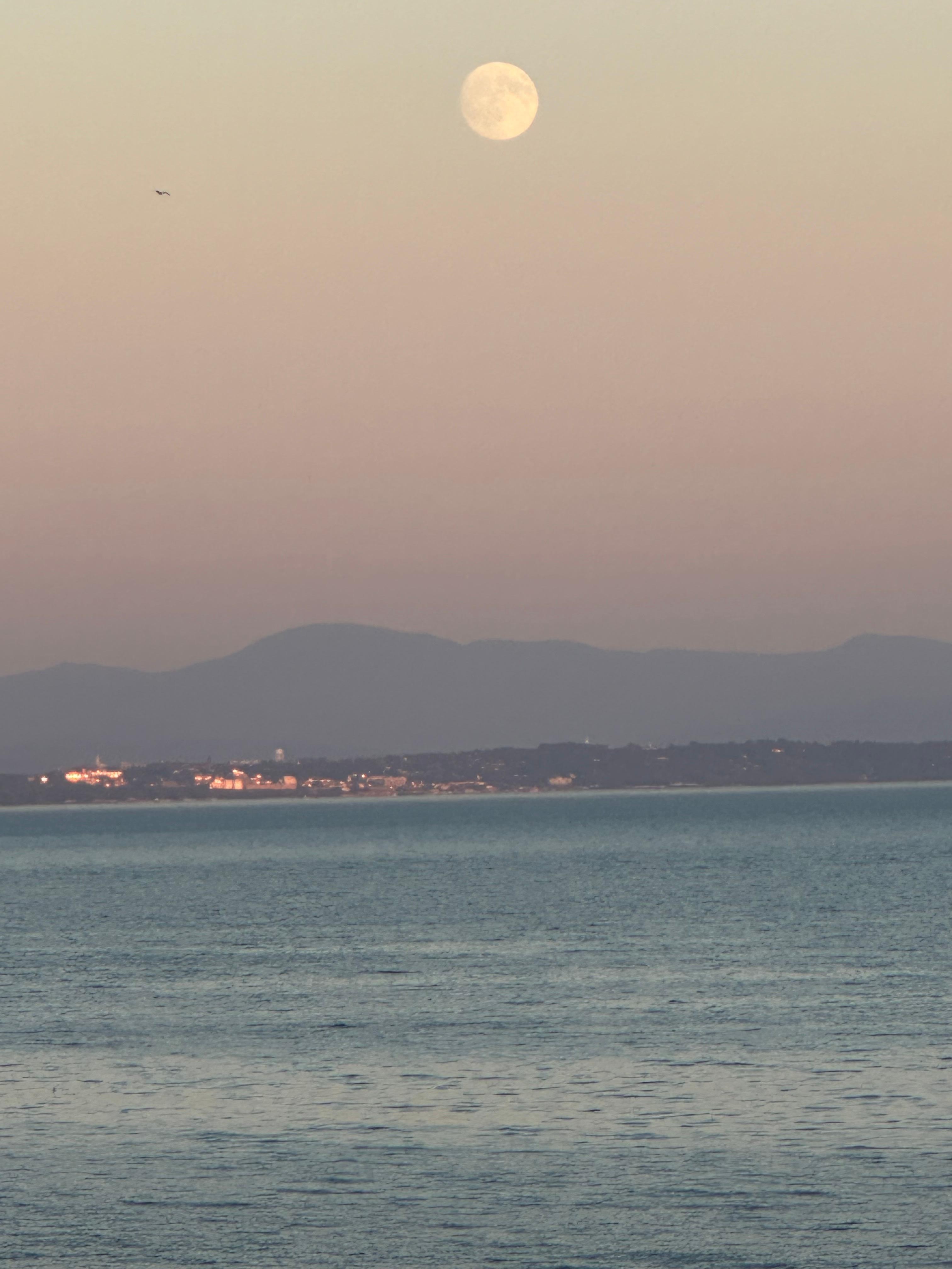Supermoon over Lake Champlain with the lights of Burlington, Vermont in the distance.  This is the view from the front of the house.