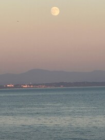 Supermoon over Lake Champlain with the lights of Burlington, Vermont in the distance. This is the view from the front of the house.