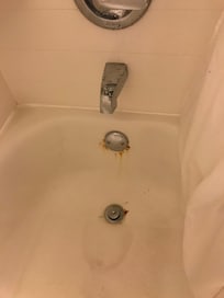 Rust around bathtub faucet (so gross)