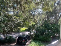 View of street from porch off of master bedroom. Gorgeous landscaping!