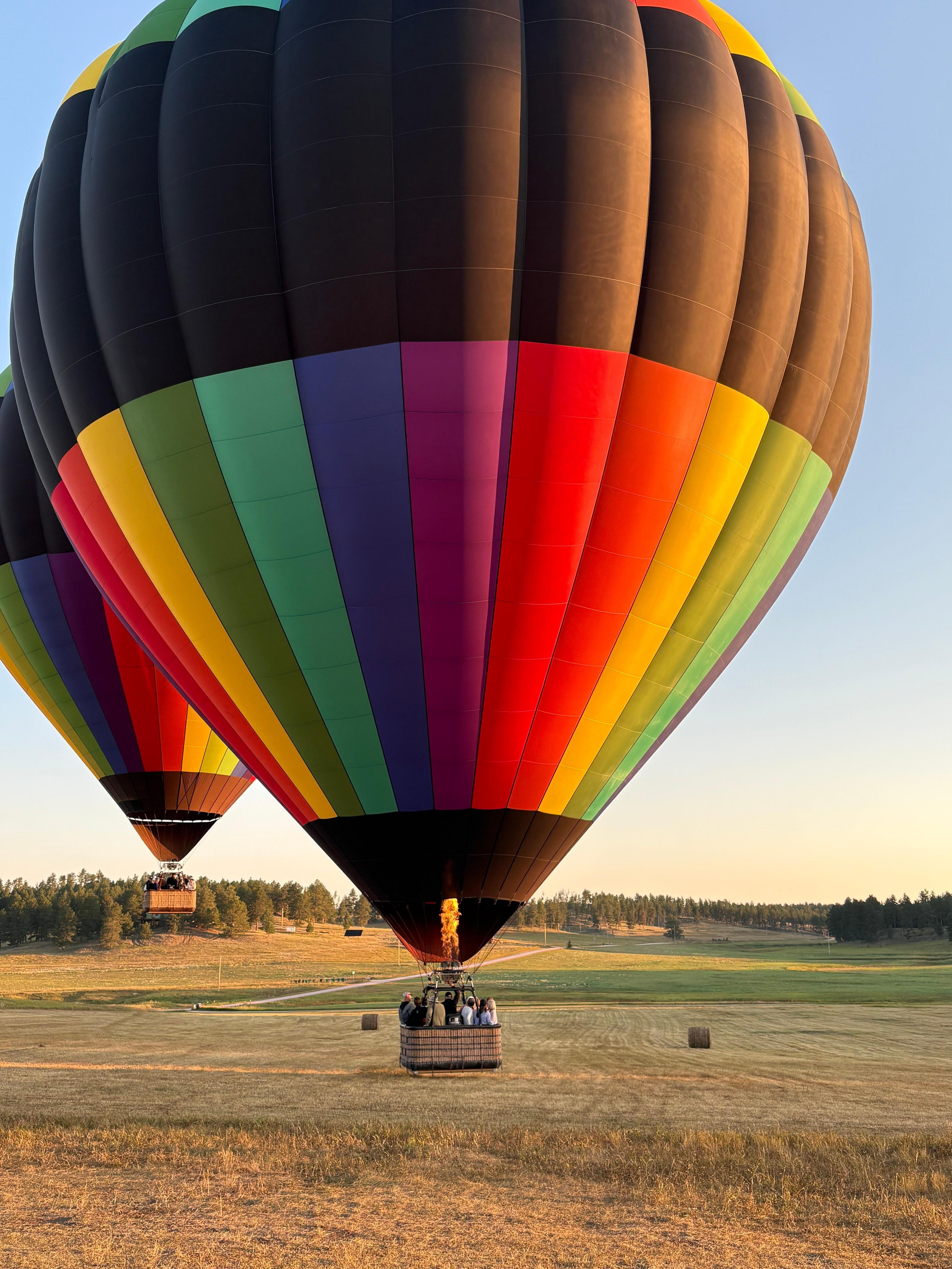 Hot air balloon ride in field near the house