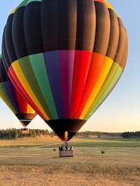 Hot air balloon ride in field near the house