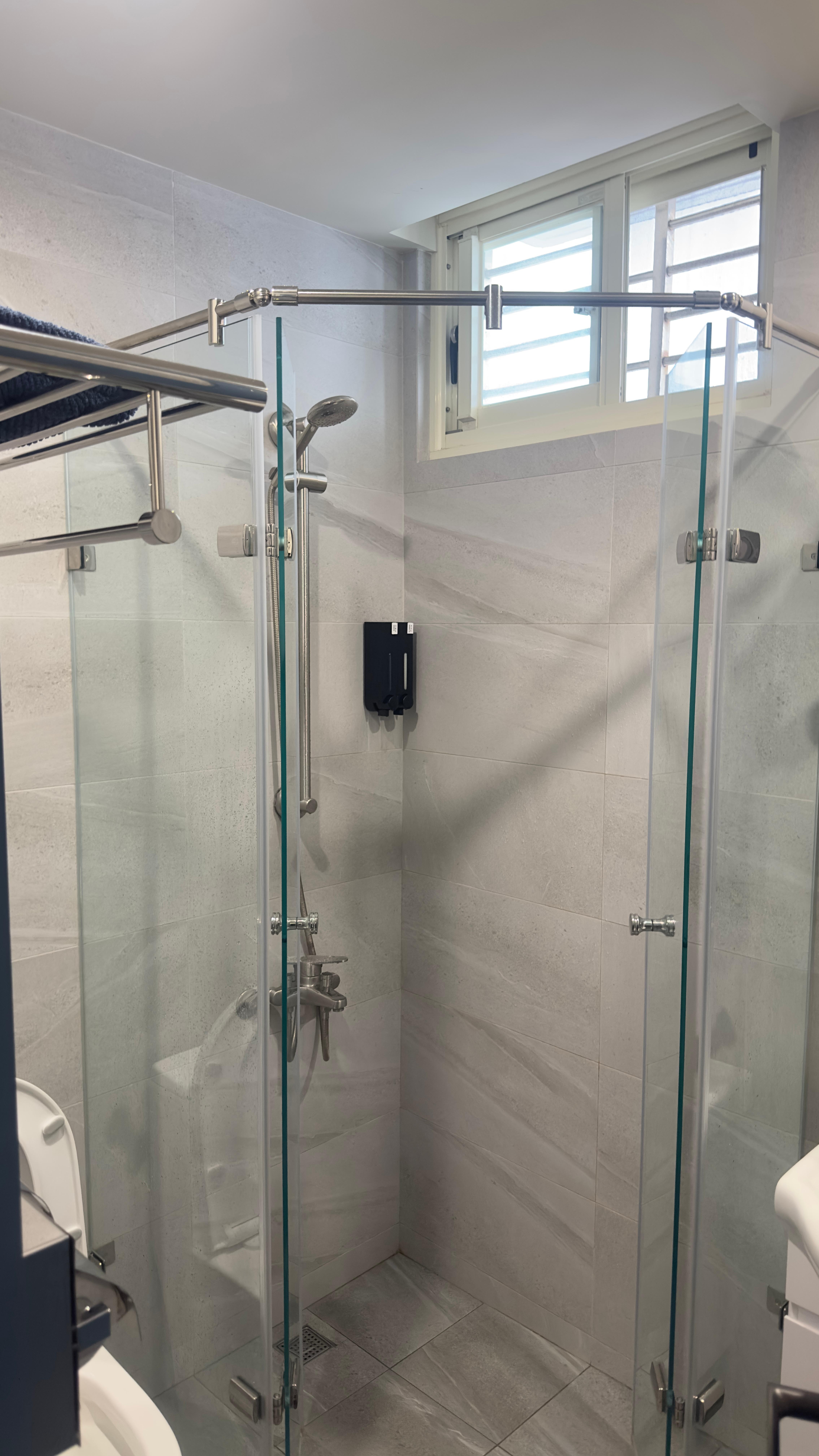 Low hanging towel rack as you enter washroom, upper left corner