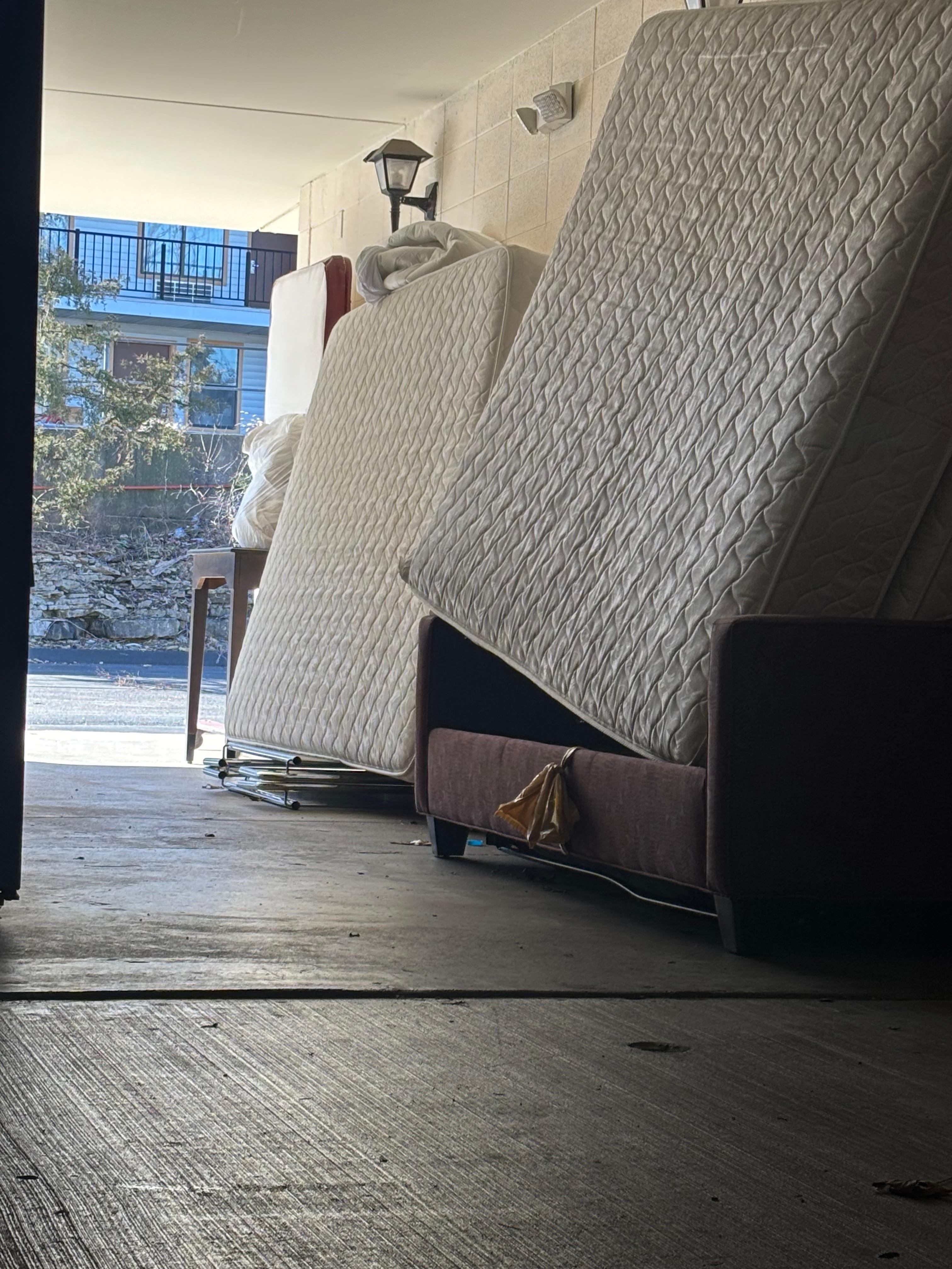 Mattresses piled on the second floor of the other building. Not an attractive site.