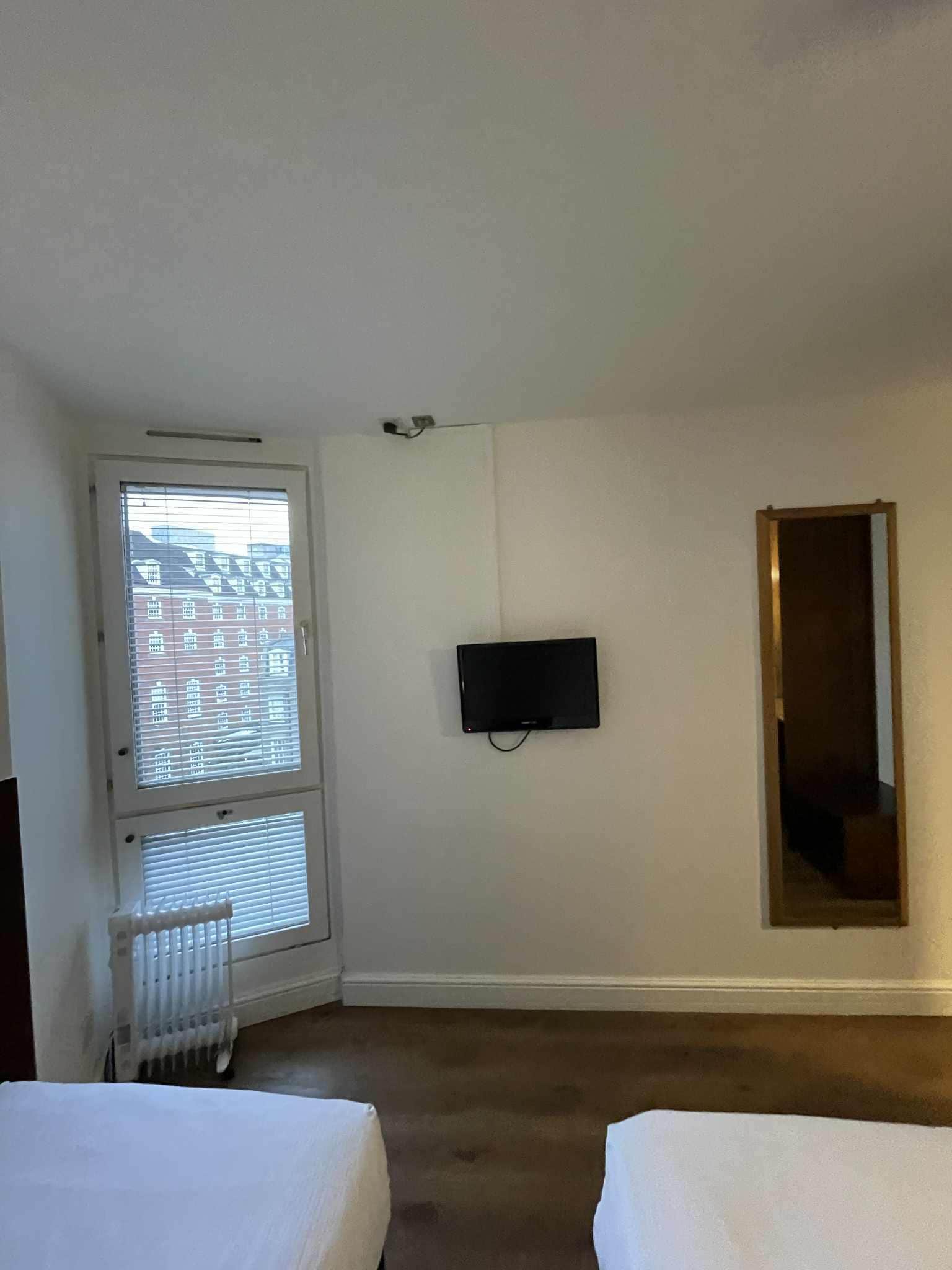 A very small TV and a mirror.