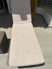 soiled and torn lounge chair