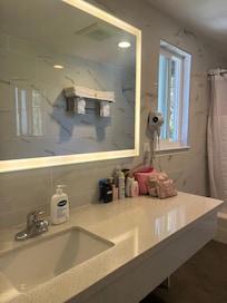 The restroom mirror and countertops were so pretty and spacious.